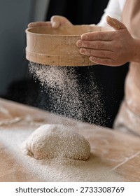 Making homemade sourdough bread involves sifting the flour.