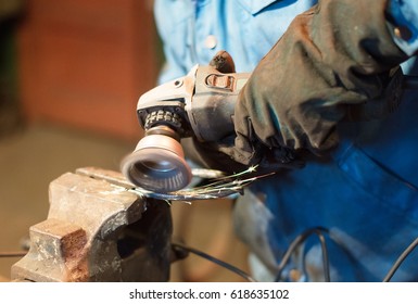 Making of horseshoe. Male worker polishing horseshoe. - Powered by Shutterstock