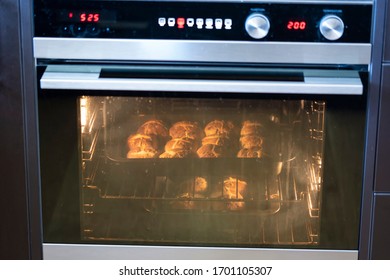 Making Hot Cross Buns On Good Friday At Easter. The Buns Are In An Oven Baking