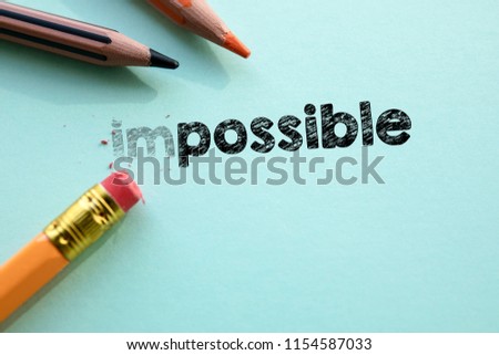 Making impossible in to possible by eraser. Cencept for action and reaching goals. 