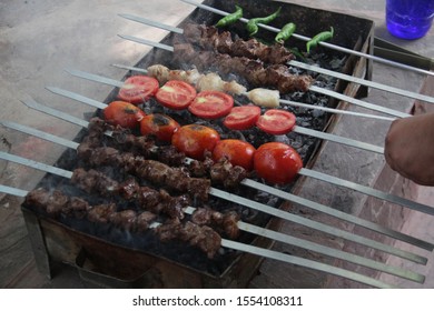 Making Kabob And Tomatoes On A Grill. 