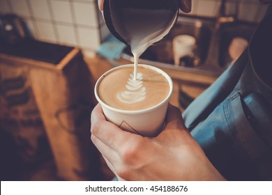 Making Of Latte Art In Paper Cup By Barista. Milk And Coffee In Vintage Color
