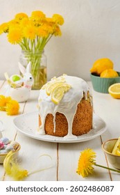 Making lemon cake or Easter cake with sugar icing on white wooden background. Easter food, baking. Happy Easter