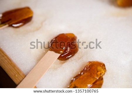 Making maple candy on snow in a maple sugar camp in New Brunswick