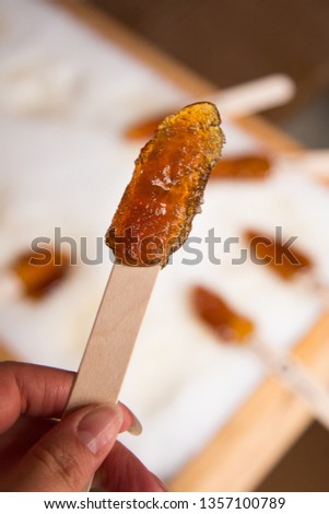 Making maple candy on snow in a maple sugar camp in New Brunswick