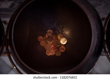 Making Merit By Donating Coins In Monk's Alms Bowl At Wat Pho, Bangkok, Thailand