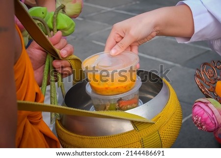 Making merit and offering food to Buddhist monks is to put food and flowers.