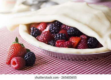 The Making Of A Mixed Berry Pie: The Top Crust Is Placed Over The Berries