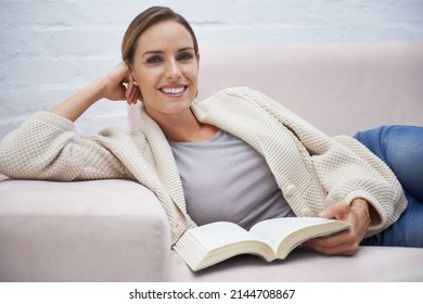 Making The Most Of Her Time Off. Cropped Shot Of An Attractive Young Woman Relaxing On The Sofa At Home.