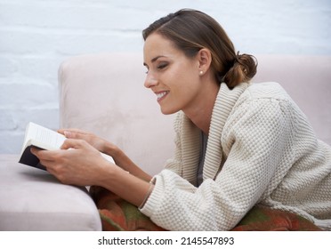 Making The Most Of Her Time Off. Cropped Shot Of An Attractive Young Woman Relaxing On The Sofa At Home.