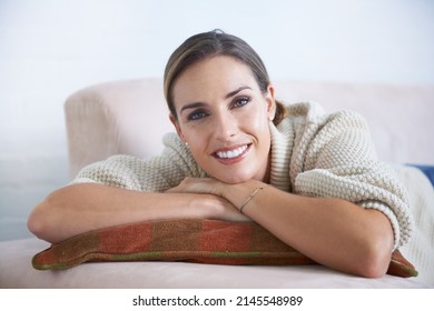 Making The Most Of Her Time Off. Cropped Shot Of An Attractive Young Woman Relaxing On The Sofa At Home.