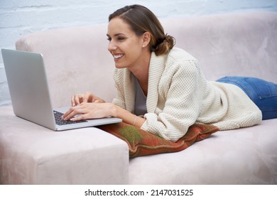 Making The Most Of Her Time Off. Cropped Shot Of An Attractive Young Woman Relaxing On The Sofa At Home.