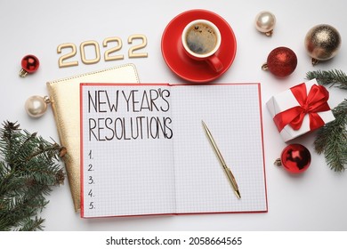 Making New Year's Resolutions. Flat Lay Composition With Notebook, 2022 Numbers And Festive Decor On White Background