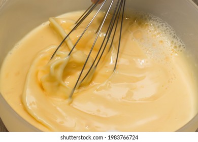 Making an omelet for breakfast. Mixing eggs and milk. - Powered by Shutterstock