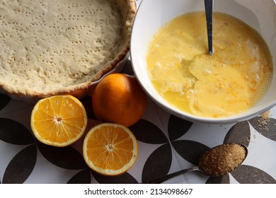 Making An Orange Pie. Top View Photo Of Fresh Ingredients On A Table. Cake Crust, Eggs, Oranges, Brown Sugar Close Up Photo. 