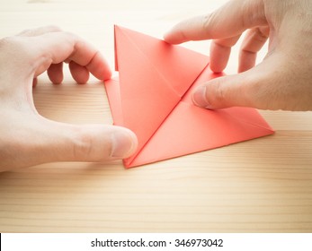 Making Origami Paper With Hands.