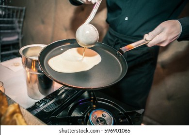 Making pancakes on frying pan, cooking class