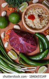 Making Pho Bo Vietnamese Soup. Serving Of Soup In A White Plate. View From Above. Fresh Natural Ingredients.