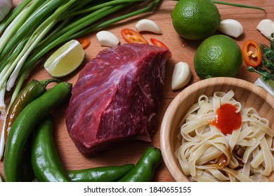 Making Pho Bo Vietnamese Soup. Serving Of Soup In A White Plate. View From Above. Fresh Natural Ingredients.