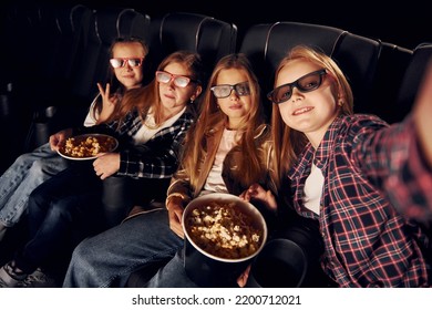 Making Photo Of Each Other. Group Of Kids Sitting In Cinema And Watching Movie Together.