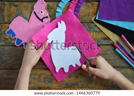 Making pink lama. Sewing toys from felt with your own hands. DIY concept for children. Handmade crafts. Step 1. Circle the stencil of toy details.