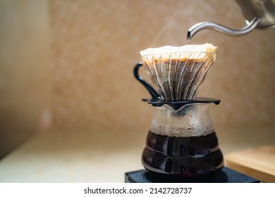 Making pour over coffee with dripper and carafe