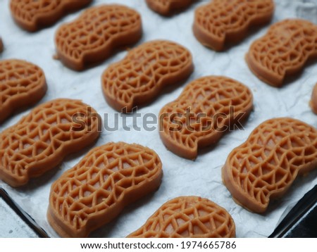 Making process of Kue kacang (Bahasa) or peanut butter cookies in baking pan. Selective focus. 