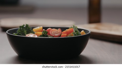 Making Salad With Kale, And Cherry Tomatoes In Black Bowl On Concrete Countertop, Wide Photo