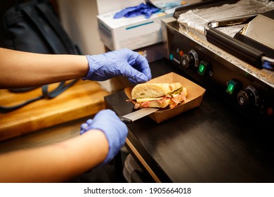 Making Sandwich In Blue Gloves