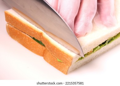 Making sandwich, cut the bread crust with a knife - Shutterstock ID 2215357581