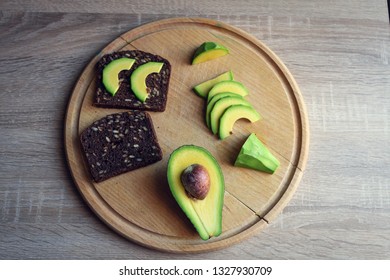 Making Sandwiches With Avocado Healthy Organic Food Top View. Avocado Sandwich On Dark Rye Bread Made With Fresh Sliced Avocados From Above. Healthy Snack. Healthy Food.