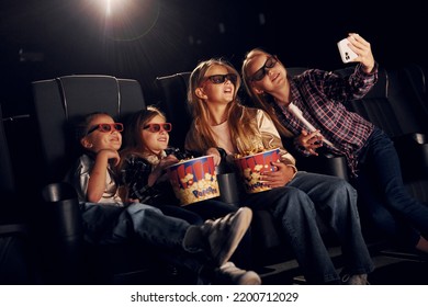 Making Selfie. Group Of Kids Sitting In Cinema And Watching Movie Together.