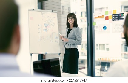 Making Sense Of Business. Shot Of A Group Of Businesspeople In A Presentation.