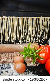 Making spaghetti with fresh basil, drying of traditional italian homemade pasta