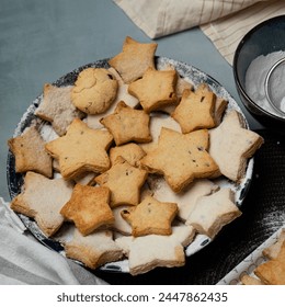 Making star-shaped shortbread cookies sprinkled with powdered sugar - Powered by Shutterstock