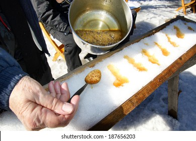 Making sugar on snow, or maple toffee at the sugar shack in Quebec, Canada