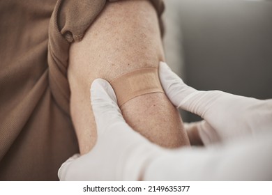 Making Sure The Area Is Protected. Closeup Shot Of An Unrecognizable Nurse Applying A Bandaid To A Patients Arm During A Checkup At Home.