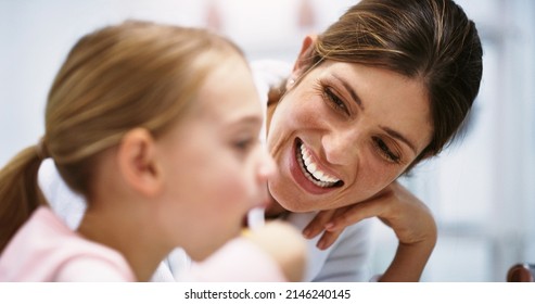 Making Sure Her Smile Is As Bright As Her Future. Shot Of A Beautiful Young Mother Watching Her Daughter Brush Her Teeth In The Bathroom At Home.