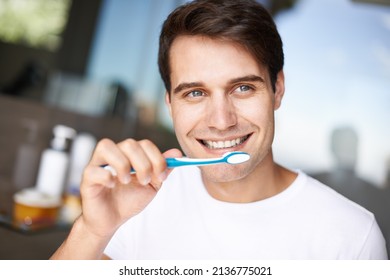 Making sure his smile sparkles. Closeup of a young man brushing his teeth.