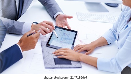 Making Sure They Pay Attention To Every Detail. Shot Of Businesspeoples Hands Around A Digital Tablet In A Meeting.