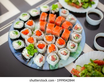 Making Sushi And Rolls At Home. Sushi With Seafood, Salad And White Rice. Food For Family And Friends. A Set Of Different Rolls And Sushi On A Tray.