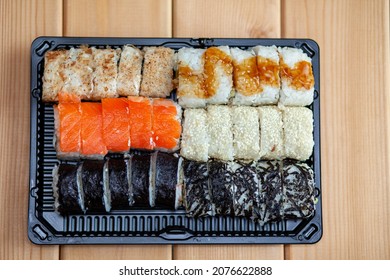 Making Sushi And Rolls At Home. Sushi With Seafood, Salad And White Rice. Food For Family And Friends. A Set Of Different Rolls And Sushi On A Tray.