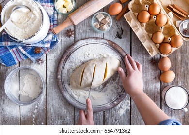 Making Sweet Bread Dough Top View. Overhead Of Baker Hands Form Bun. Cooking Ingredients For Pastry On Rustic Wood Sprinkled With Flour, Culinary Classes Or Recipe Concept.