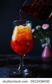 Making Thai Iced / Pouring Tea Water On Dark Moody Background, Selective Focus