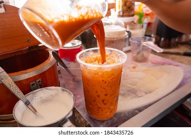 Making Of Thai Orange Traditional Milk Tea. Street Food Ready For Drink