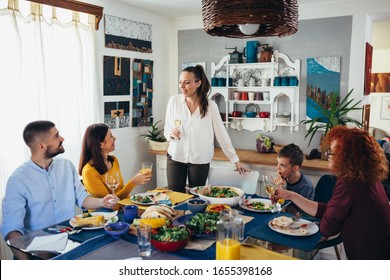 Making A Toast. Family Gathering At Home. Vegan Dinner Party