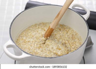 Making Traditional Scottish Porridge By Wooden Spurtle