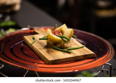 Making Of Tuna Salad In Hot Potato With Tomato, Eggs And Herbs On Wooden Cutting Board