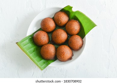 Making Unniyappam Kerala Fried Snacks  Sweet Food On Dark Black Background In India. Tea Time Food Fried In Coconut Oil. Top View Of South Indian Snacks For Festival  Onam,Vishu.