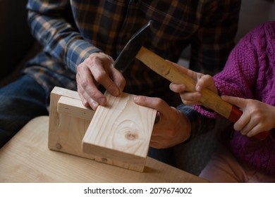 Making a wooden bird feeder. Dad and daughter are doing together. The concept of spending time together. Bird care
